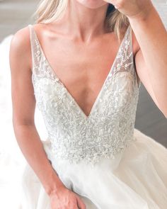 a woman in a wedding dress brushing her teeth