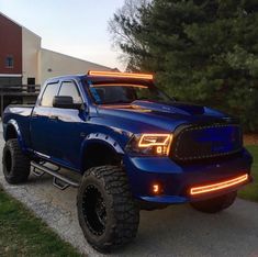 a large blue truck parked in front of a building