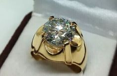 a gold ring with a large diamond in it