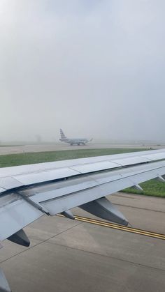 the wing of an airplane as it sits on the tarmac