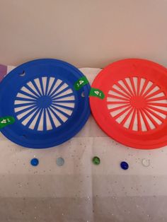 two frisbees are hanging on the wall next to each other with arrows pointing towards them