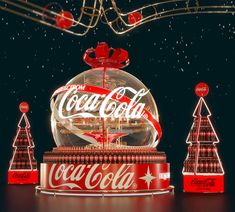 coca - cola's christmas decorations are displayed in front of a black background