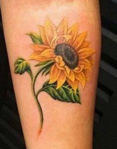 a sunflower with green leaves on the arm