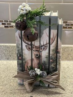 the book is decorated with flowers and deer heads on it's cover, along with pine cones