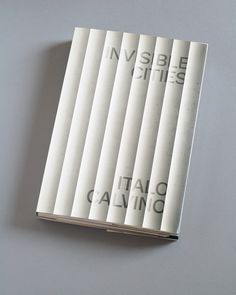 the inside pages of a book with black and white lettering on it, sitting on a table