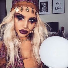 a woman with makeup and jewelry on her face