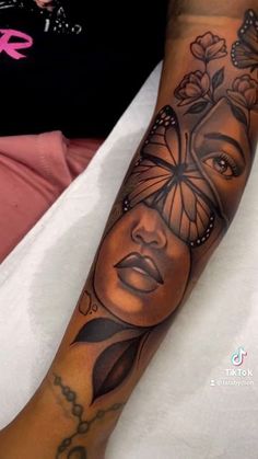 a woman's arm with a butterfly tattoo on it