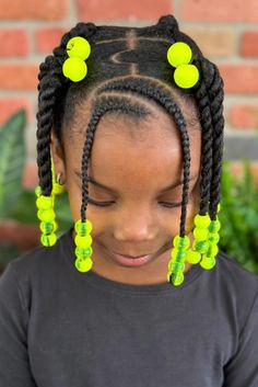 This delightful crocheted hairstyle showcases thick, artfully woven braids that symmetrically frame the face, resulting in a playful and tidy appearance ideal for children. Vibrant green beads adorn the ends of each braid, adding a pop of color and a whimsical touch, while also serving the practical purpose of - Click to see more of Fun and Creative Crochet Styles for Kids: 21 Ideas to Spark Their Imagination and follow us for more hairstyle ideas. // Photo Credit: Instagram @koily_kali Toddler Hairstyles Girl