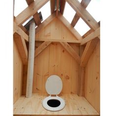 a toilet in the middle of a wooden structure