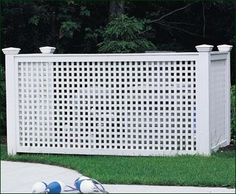 a white fence sitting on top of a lush green field