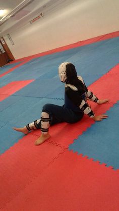 a woman sitting on the ground wearing knee pads