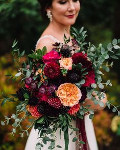 a woman holding a bouquet of flowers in her hands