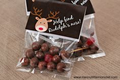 chocolate candies wrapped in cellophane and decorated with reindeer antlers are on the table