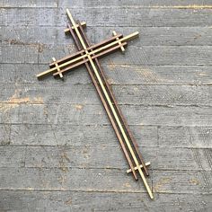 a wooden cross laying on top of a wooden floor