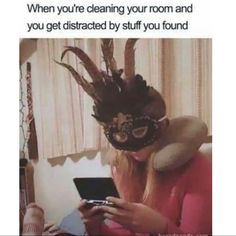 a woman wearing a masquerade while looking at her cell phone and texting