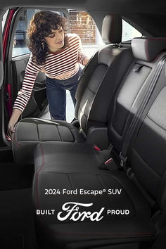 a woman in the back seat of a car looking at something on the floor with words ford escape suv built to order