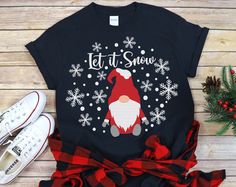 a t - shirt that says let it snow with a santa clause on it