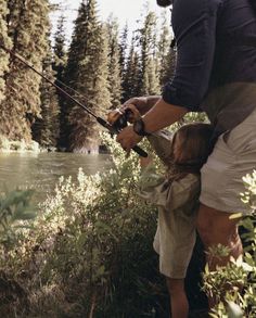 a father and daughter fishing in the woods