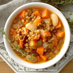 a white bowl filled with carrots and lentils