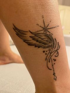 a close up of a person's foot with an angel tattoo on the ankle