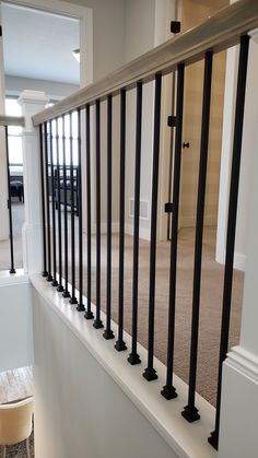 an empty room with white walls and black railings