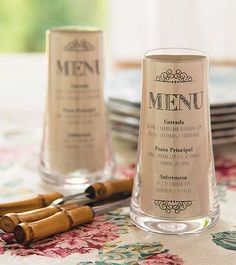 a table topped with two glasses and cinnamon sticks