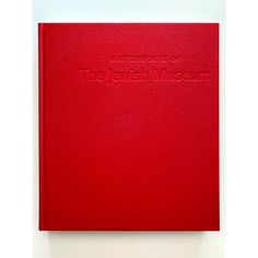 a red book sitting on top of a white table