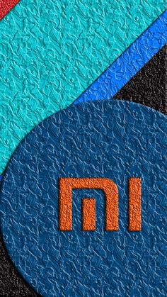 an orange and blue letter m on a black background with two smaller letters in the middle