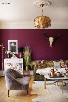 a living room with purple walls and gold accents