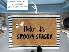 a door mat that says hello it's spooky season