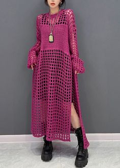 a woman standing in front of a wall wearing a pink crochet dress and black boots