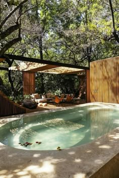 an outdoor swimming pool surrounded by trees