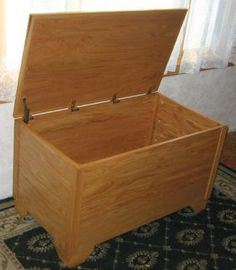 an empty wooden chest sitting on top of a rug