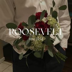 a man in a white shirt holding a red and green bouquet with the words roosevelt rose field