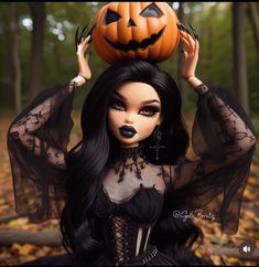 a doll dressed up as a witch holding a jack - o'- lantern on her head