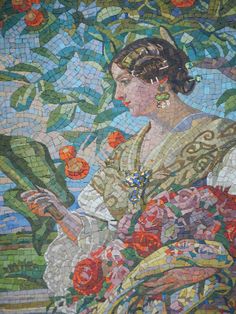 a woman with flowers in her hair is depicted on a mosaic wall