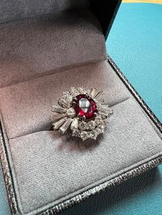 A dainty ballerina 40's style starburst ring.  Packed with real diamonds in round and baguette cuts, surrounding a beautiful lab-grown ruby (identified by my jeweler.)  White gold. Size 7-7.25 US; measures approx 17mm across the inside of the band.  Ruby is approx 8mm long; 7mm wide.  All pieces in my shop are insured during shipping at no extra cost to you!  This ring is from an estate collection of a family friend.  She was a lovely fashion model, a world traveler, and with her most popular years in the 80s and 90s.  She found home in her later years in beautiful Colorado.  She had an eclectic style and it's time to share with the world. Will consider offers! Just send me a message or use the offer button SHOP POLICY: Each piece in my shop is part of an estate collection, comprised of vi 40's Style, Ballerina Ring, Starburst Ring, Blood Ruby, Lovely Fashion, 40s Fashion, Family Friend, Eclectic Style, World Traveler