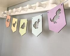 some paper animals are hanging on a clothes line