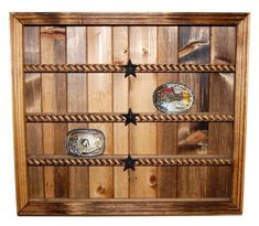 a wooden display case with three rings and stars on the front, one ring in the middle