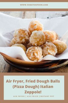 a bowl filled with fried dough balls sitting on top of a table