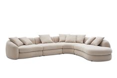 a large sectional couch with pillows on the top and bottom corner, in beige fabric