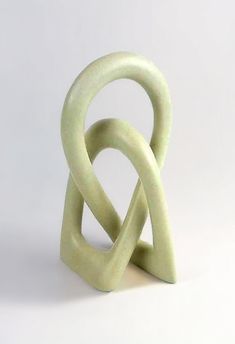 a sculpture made out of white marble on a white background with the shape shaped like an interlocking knot