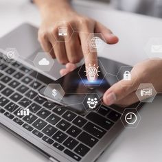 a person using a laptop computer with icons coming out of the screen and on top of it