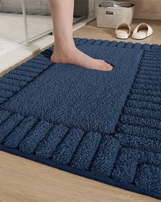 a person is standing on a blue rug