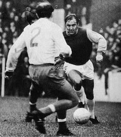 an old photo of two men playing soccer