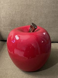 an apple shaped object sitting on top of a couch