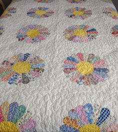 a quilted bedspread with colorful flowers on it