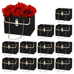 six black boxes with gold chains and roses in them