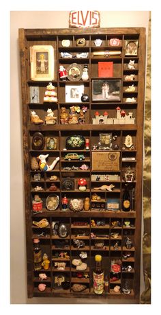 a wooden shelf filled with lots of different types of items on top of each other