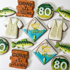 decorated cookies are arranged in the shape of fishing related items